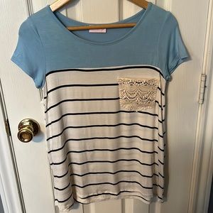 Pink Lily White top with black stripes. Blue across shoulders and lace pocket